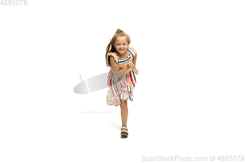 Image of Happy little caucasian girl jumping and running isolated on white background