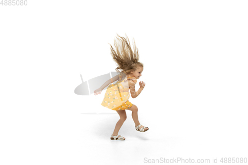 Image of Happy little caucasian girl jumping and running isolated on white background