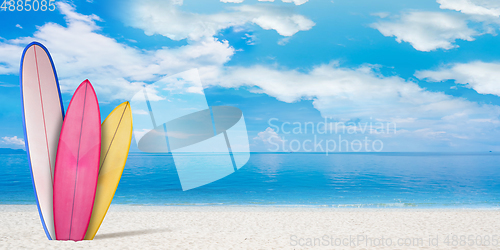 Image of Summer concept flyer. Surfing boards with beach, sand and ocean or sea on background