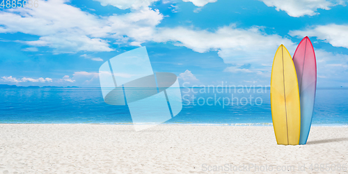 Image of Summer concept flyer. Surfing boards with beach, sand and ocean or sea on background