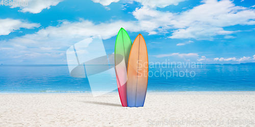 Image of Summer concept flyer. Surfing boards with beach, sand and ocean or sea on background