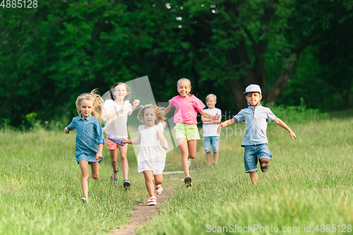 Image of Kids, children running on meadow in summer\'s sunlight