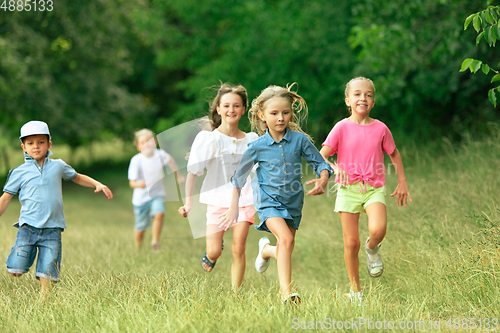 Image of Kids, children running on meadow in summer\'s sunlight