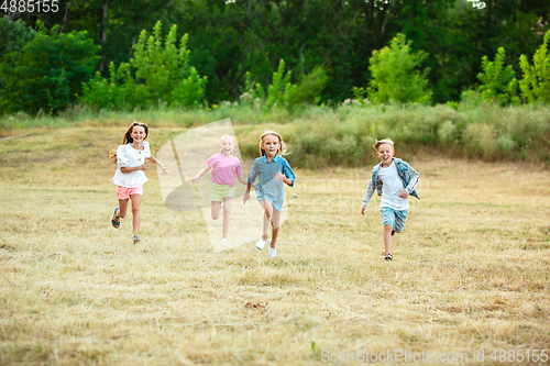 Image of Kids, children running on meadow in summer\'s sunlight