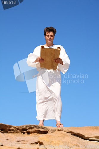 Image of Man in robe reading 