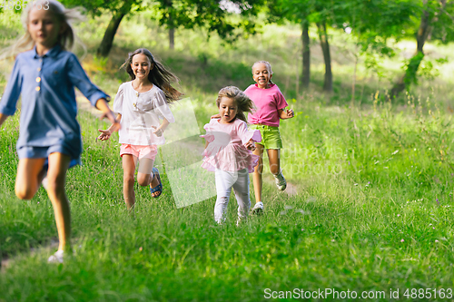 Image of Kids, children running on meadow in summer\'s sunlight