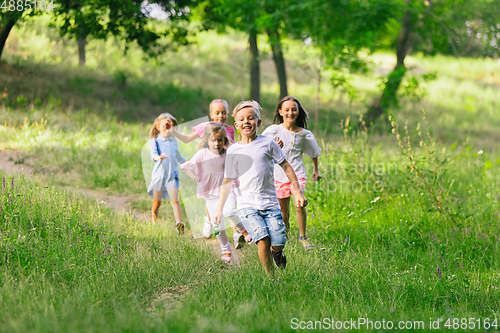 Image of Kids, children running on meadow in summer\'s sunlight