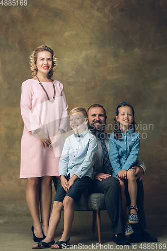 Image of Happy family traditional portrait, old-fashioned. Cheerful parents and kids