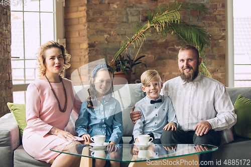 Image of Happy family traditional portrait, old-fashioned. Cheerful parents and kids