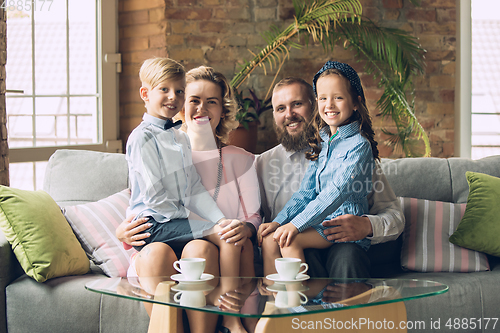 Image of Happy family traditional portrait, old-fashioned. Cheerful parents and kids