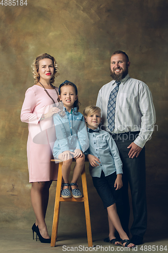 Image of Happy family traditional portrait, old-fashioned. Cheerful parents and kids