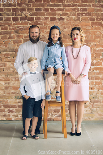 Image of Happy family traditional portrait, old-fashioned. Cheerful parents and kids