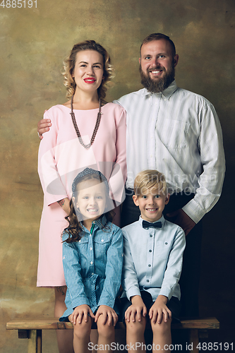 Image of Happy family traditional portrait, old-fashioned. Cheerful parents and kids