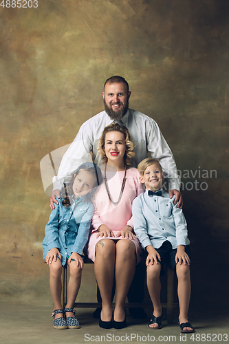 Image of Happy family traditional portrait, old-fashioned. Cheerful parents and kids