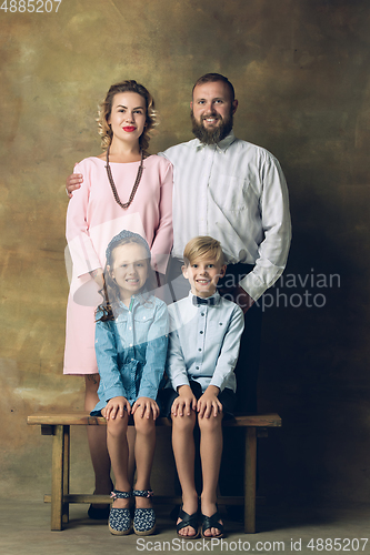 Image of Happy family traditional portrait, old-fashioned. Cheerful parents and kids