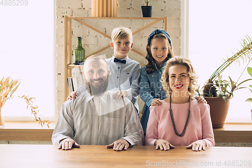 Image of Happy family traditional portrait, old-fashioned. Cheerful parents and kids