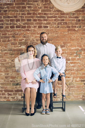 Image of Happy family traditional portrait, old-fashioned. Cheerful parents and kids