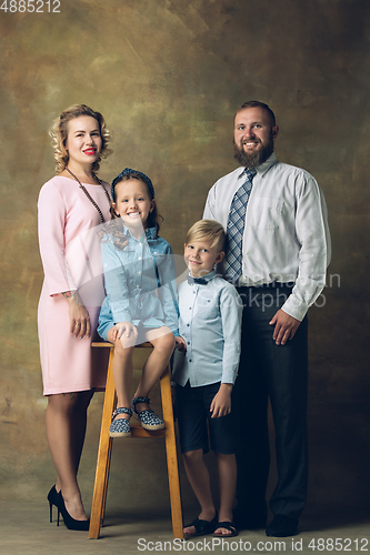 Image of Happy family traditional portrait, old-fashioned. Cheerful parents and kids