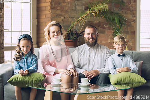 Image of Happy family traditional portrait, old-fashioned. Cheerful parents and kids