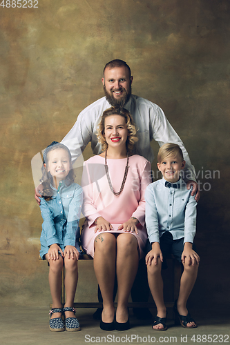 Image of Happy family traditional portrait, old-fashioned. Cheerful parents and kids