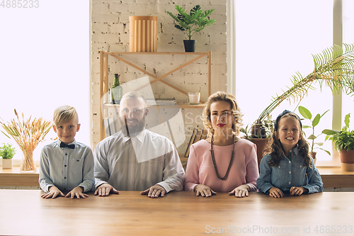 Image of Happy family traditional portrait, old-fashioned. Cheerful parents and kids