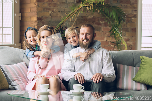 Image of Happy family traditional portrait, old-fashioned. Cheerful parents and kids