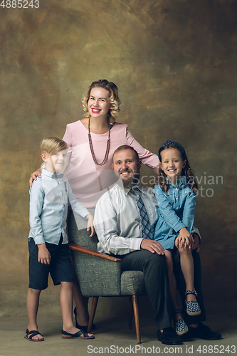 Image of Happy family traditional portrait, old-fashioned. Cheerful parents and kids