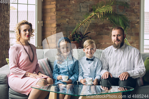 Image of Happy family traditional portrait, old-fashioned. Cheerful parents and kids