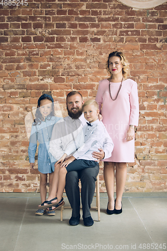 Image of Happy family traditional portrait, old-fashioned. Cheerful parents and kids