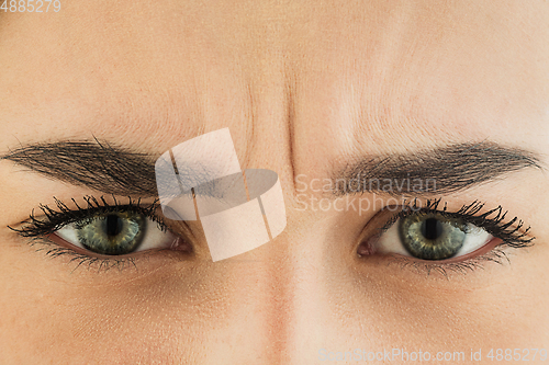 Image of Close up of face of beautiful caucasian young woman, focus on eyes. Human emotions, facial expression, cosmetology, body and skin care concept.