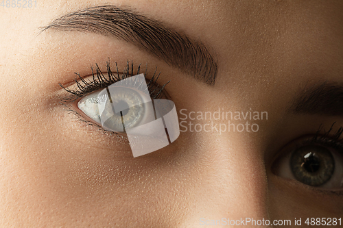 Image of Close up of face of beautiful caucasian young woman, focus on eyes. Human emotions, facial expression, cosmetology, body and skin care concept.