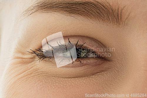 Image of Close up of face of beautiful caucasian young woman, focus on eyes. Human emotions, facial expression, cosmetology, body and skin care concept.