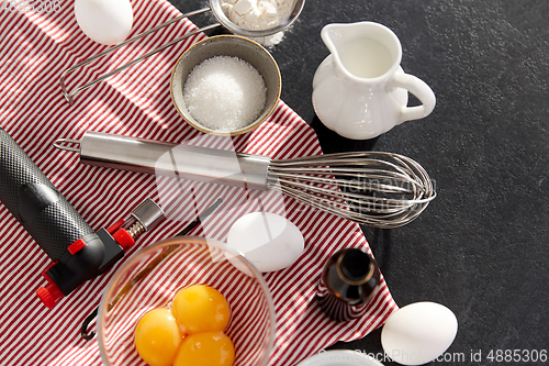 Image of whisk, eggs, sugar, milk, flour and vanilla