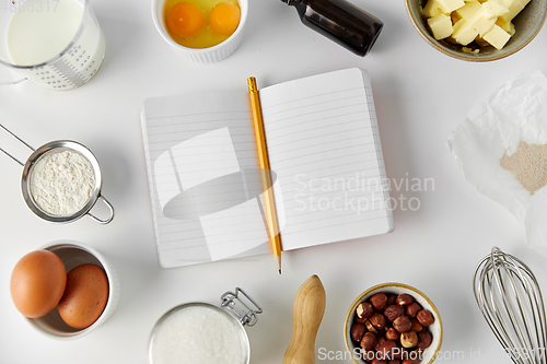 Image of recipe book and cooking ingredients on table