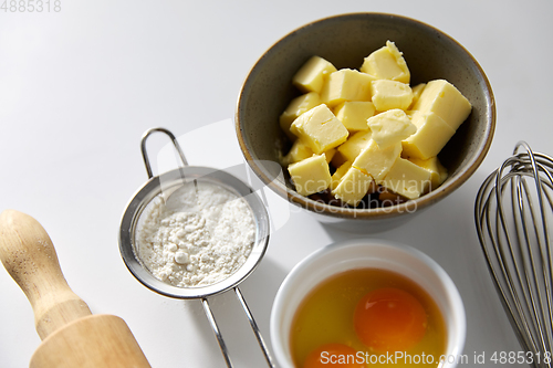 Image of rolling pin, butter, eggs, flour and whisk