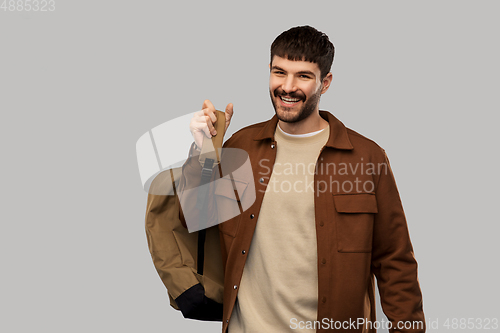 Image of happy smiling young man with backpack