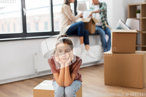 Image of sad girl moving to new home with her family