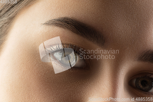 Image of Close up of face of beautiful caucasian young woman, focus on eyes. Human emotions, facial expression, cosmetology, body and skin care concept.