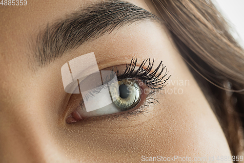 Image of Close up of face of beautiful caucasian young woman, focus on eyes. Human emotions, facial expression, cosmetology, body and skin care concept.