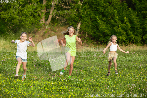 Image of Kids, children running on meadow in summer\'s sunlight