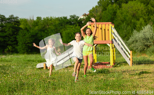 Image of Kids, children running on meadow in summer\'s sunlight