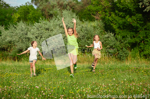 Image of Kids, children running on meadow in summer\'s sunlight