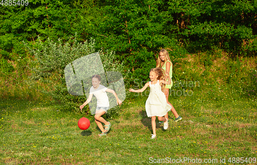 Image of Kids, children running on meadow in summer\'s sunlight