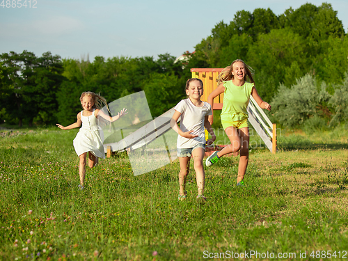 Image of Kids, children running on meadow in summer\'s sunlight