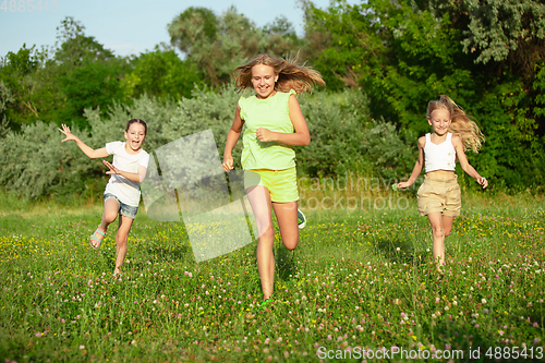 Image of Kids, children running on meadow in summer\'s sunlight