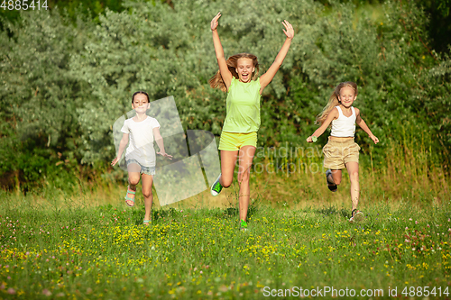 Image of Kids, children running on meadow in summer\'s sunlight