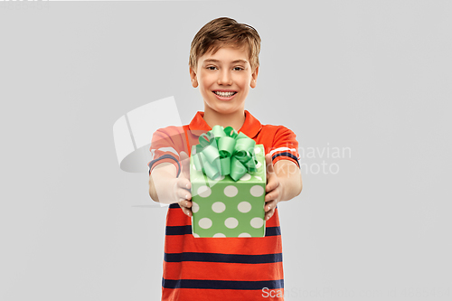 Image of portrait of happy smiling boy with gift box