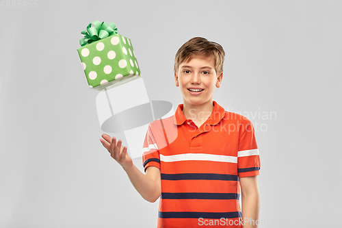 Image of portrait of happy smiling boy with gift box
