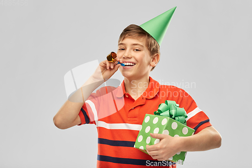 Image of happy boy in party hat with birthday gift box