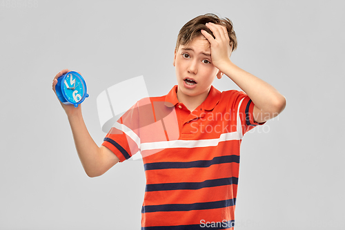 Image of portrait of boy with alarm clock